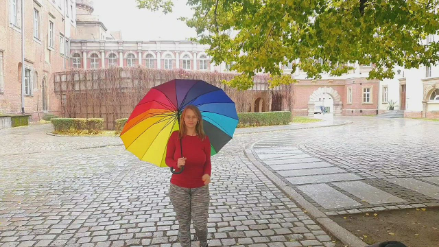 A normal, unassuming girl on a walk with an umbrella.