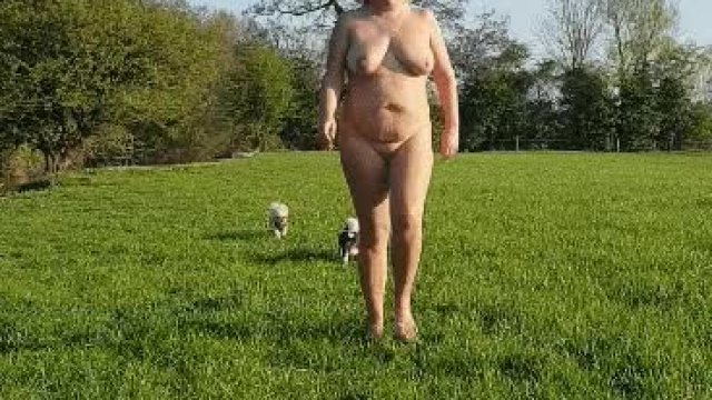Chubby blonde walking nude in a field
