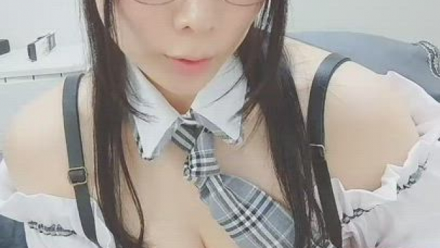 Busty Japanese schoolgirl revealing her tits